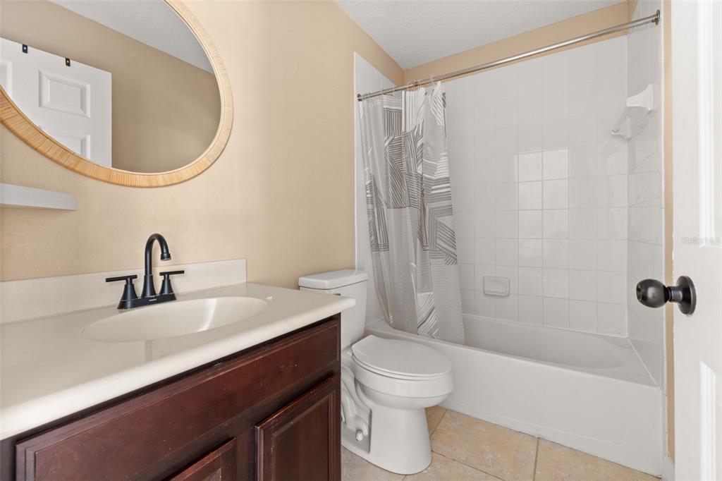 811 Assembly Court Reunion, FL 34747 - Photo 25 of 84 a bathroom with a sink a toilet and a mirror