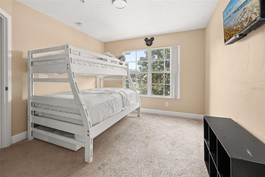 811 Assembly Court Reunion, FL 34747 - Photo 26 of 84 a bedroom with a bed and a window