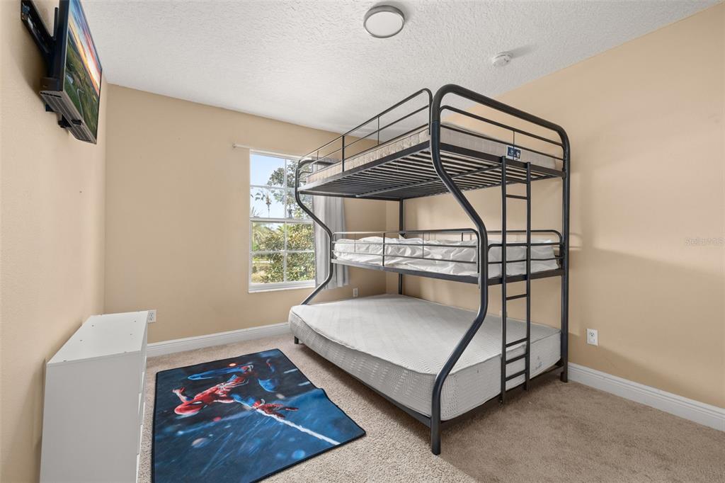 811 Assembly Court Reunion, FL 34747 - Photo 29 of 84 a bedroom with a bed and a window
