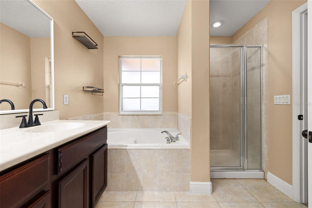 811 Assembly Court Reunion, FL 34747 - Photo 37 of 84 a bathroom with a bathtub and a sink