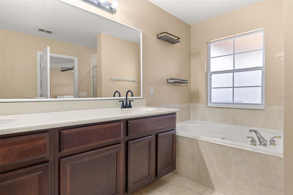 811 Assembly Court Reunion, FL 34747 - Photo 38 of 84 a bathroom with a sink and a bathtub