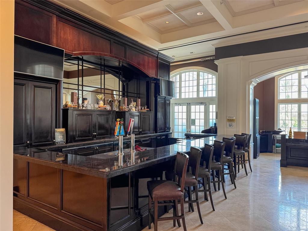 811 Assembly Court Reunion, FL 34747 - Photo 80 of 84 a kitchen with stainless steel appliances a dining table and chairs
