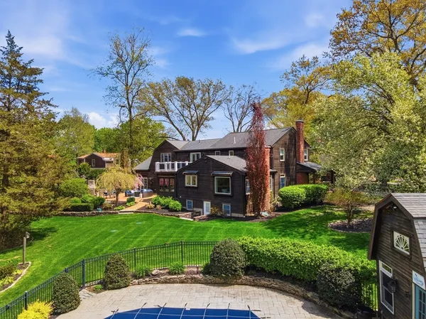 a view of a backyard with chair and a fire pit