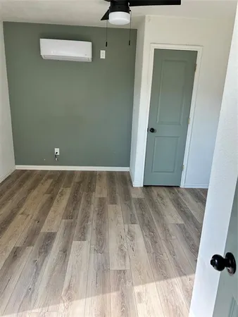 a view of a room with wooden floor