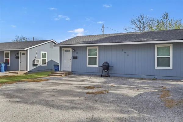 a view of a house with a backyard and a tree