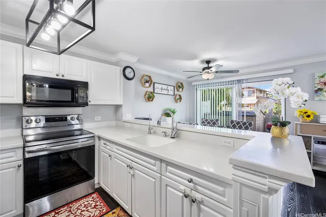 a kitchen with stainless steel appliances a stove microwave and sink