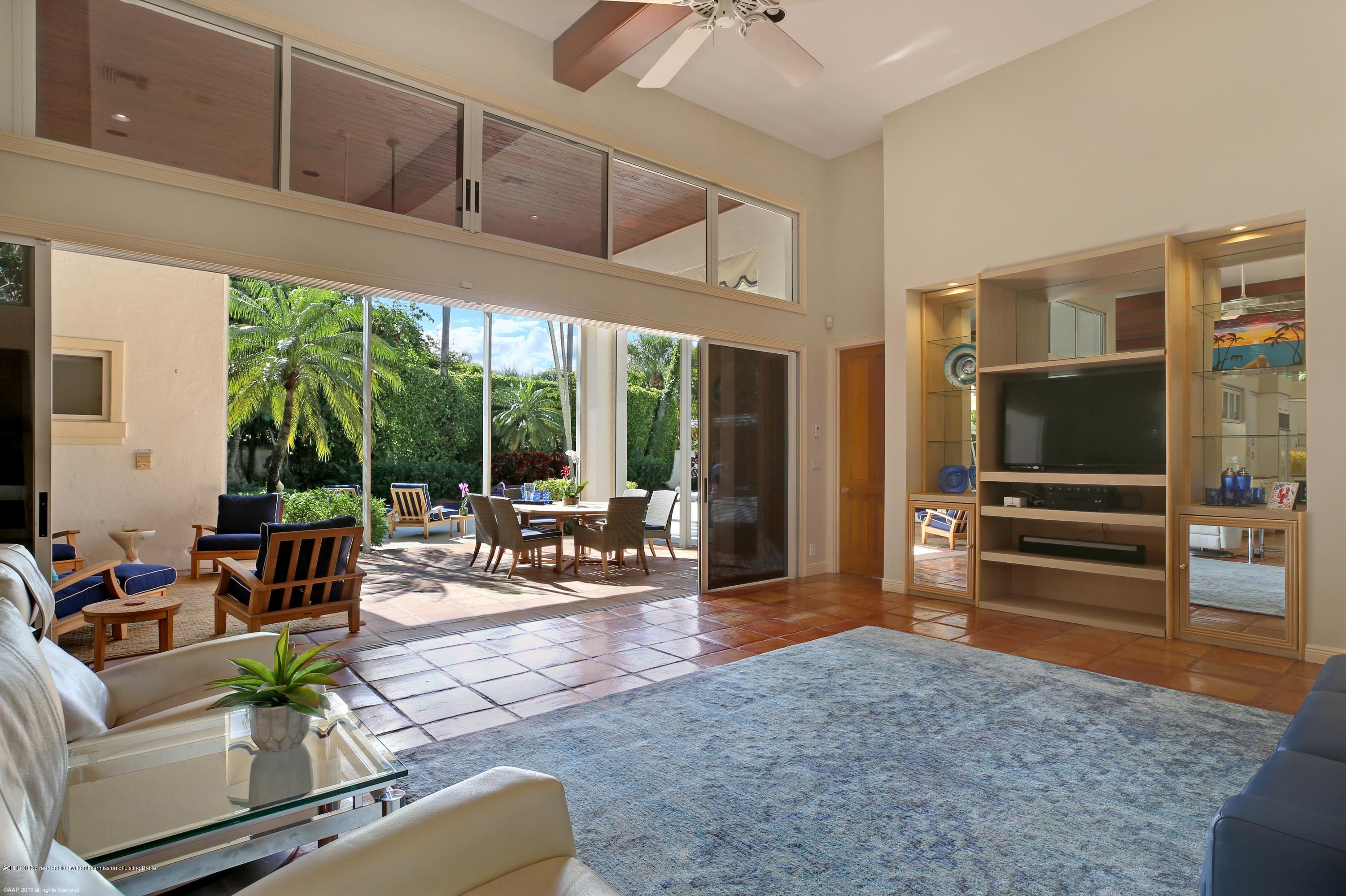 210 Wells Road Palm Beach, FL 33480 - Photo 16 of 65 a living room with furniture tv and large window