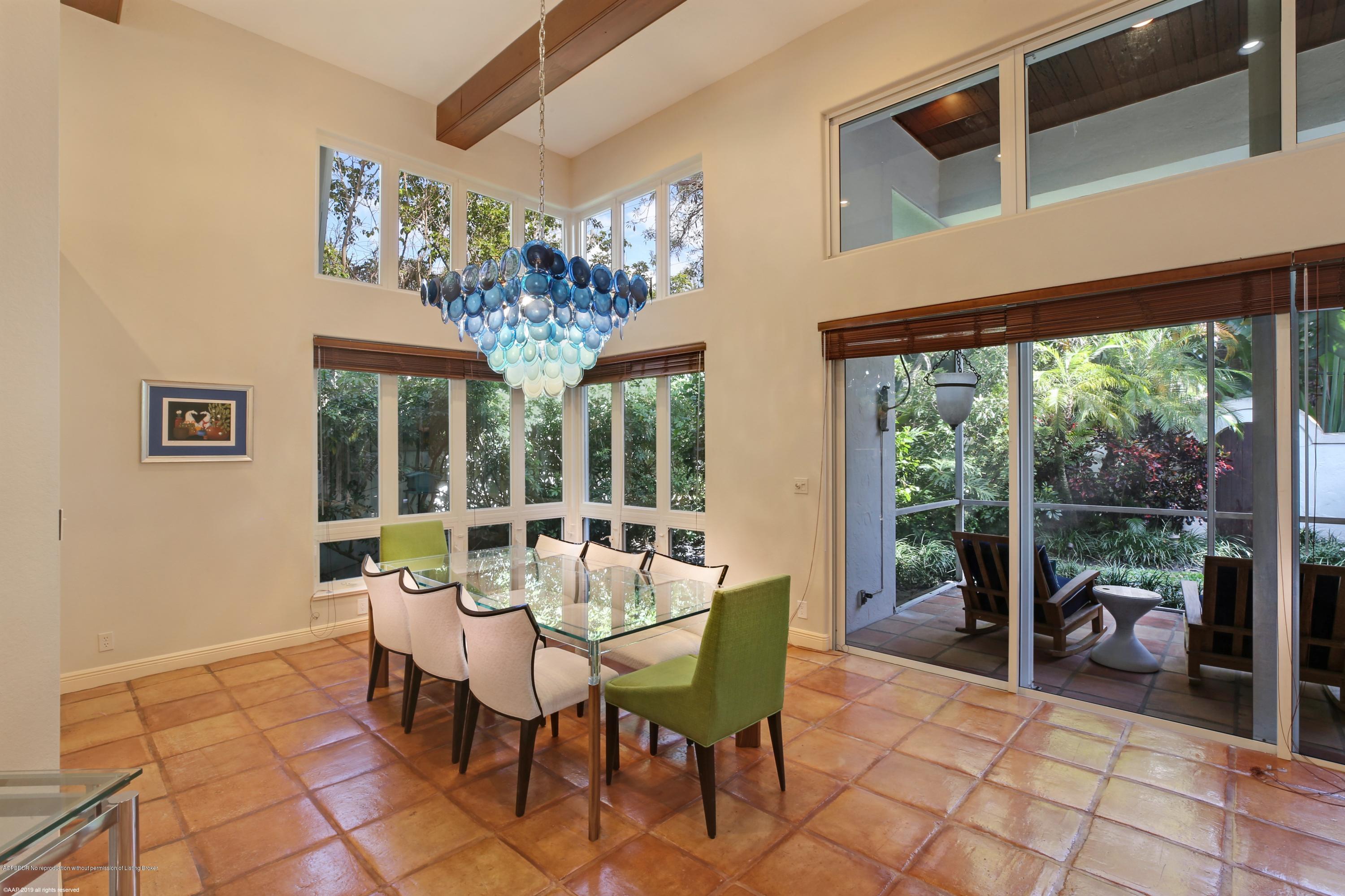 210 Wells Road Palm Beach, FL 33480 - Photo 20 of 65 a dining room with furniture a chandelier and a rug
