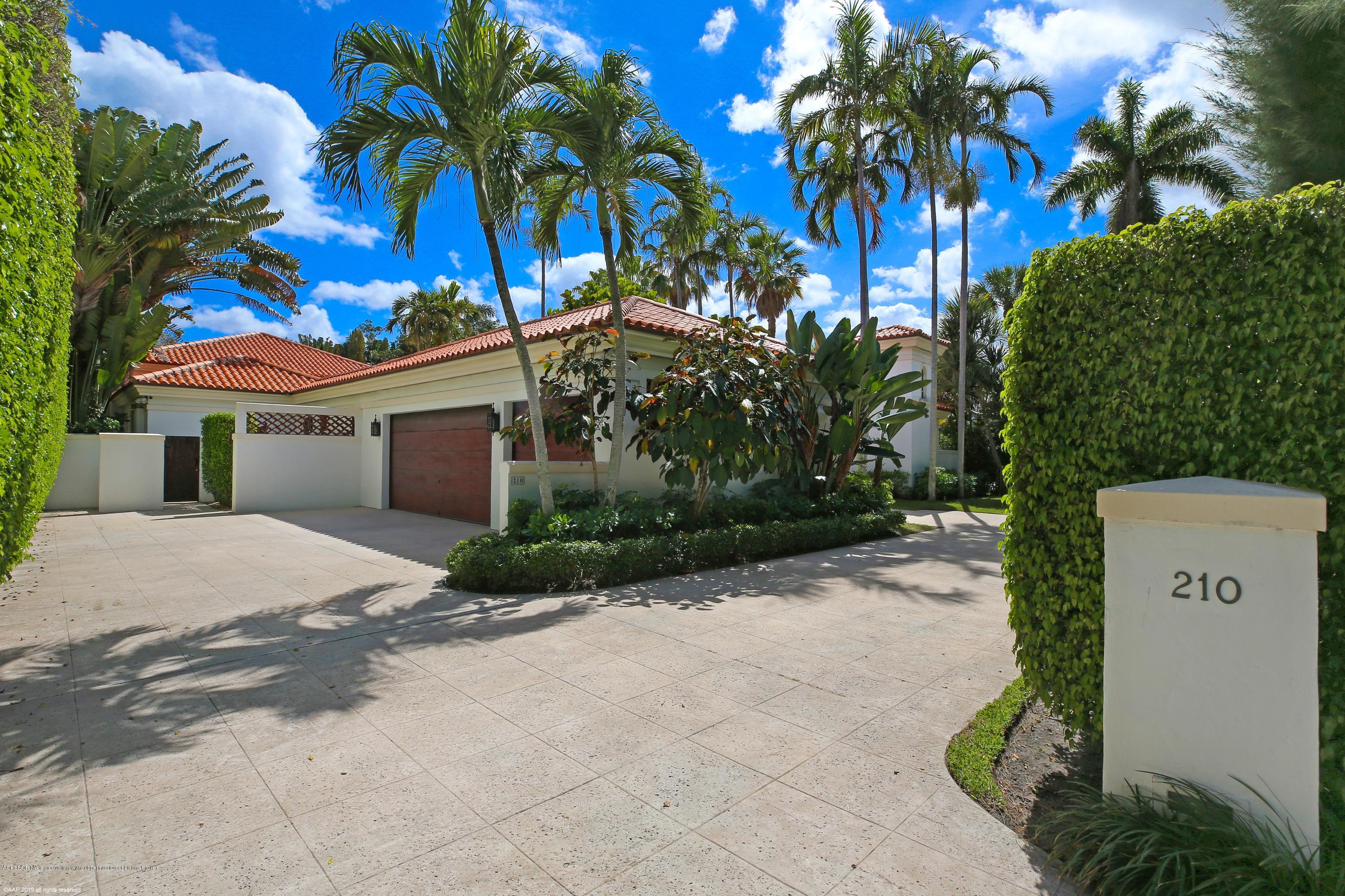 210 Wells Road Palm Beach, FL 33480 - Photo 3 of 65 a view of a house with a yard and palm trees