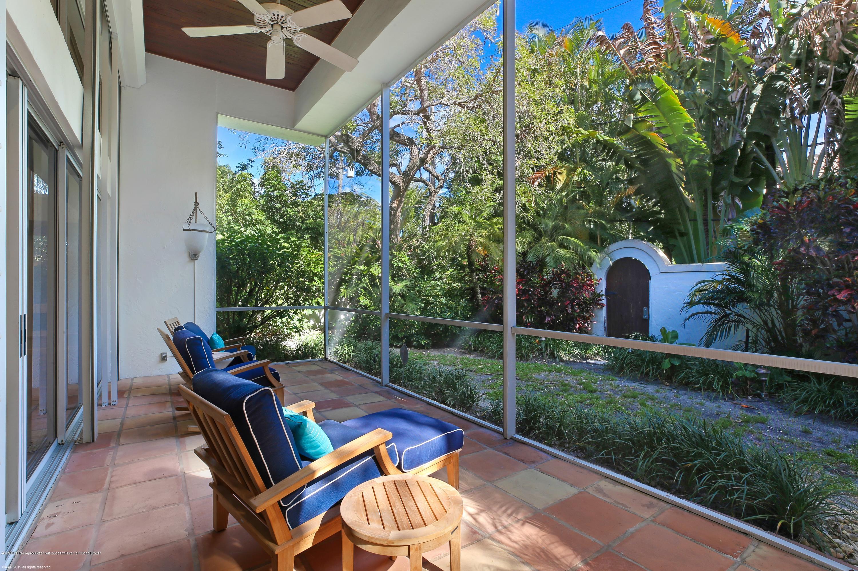 210 Wells Road Palm Beach, FL 33480 - Photo 21 of 65 a backyard of a house with table and chairs and potted plants