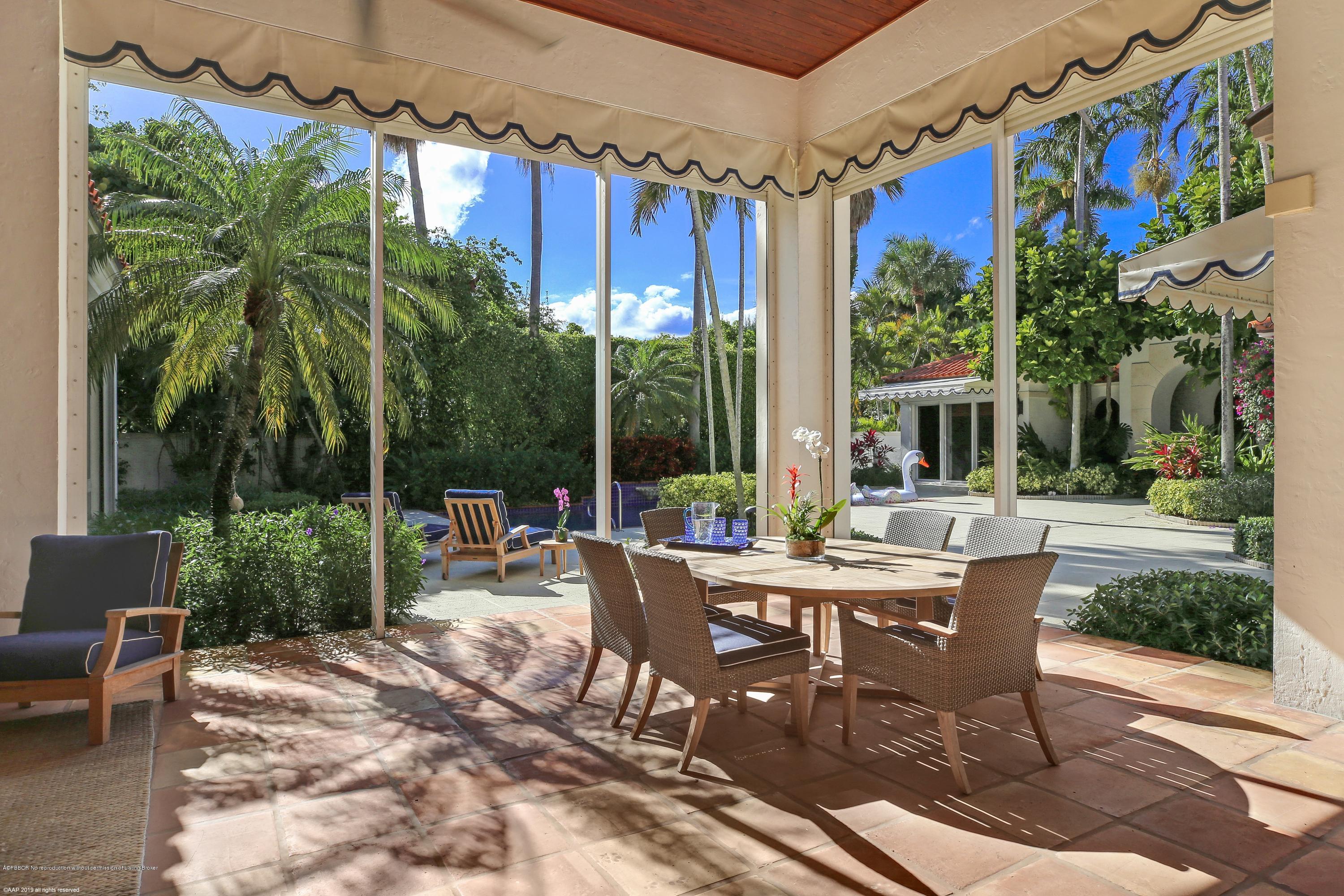 210 Wells Road Palm Beach, FL 33480 - Photo 24 of 65 a view of a patio with a dining table and chairs