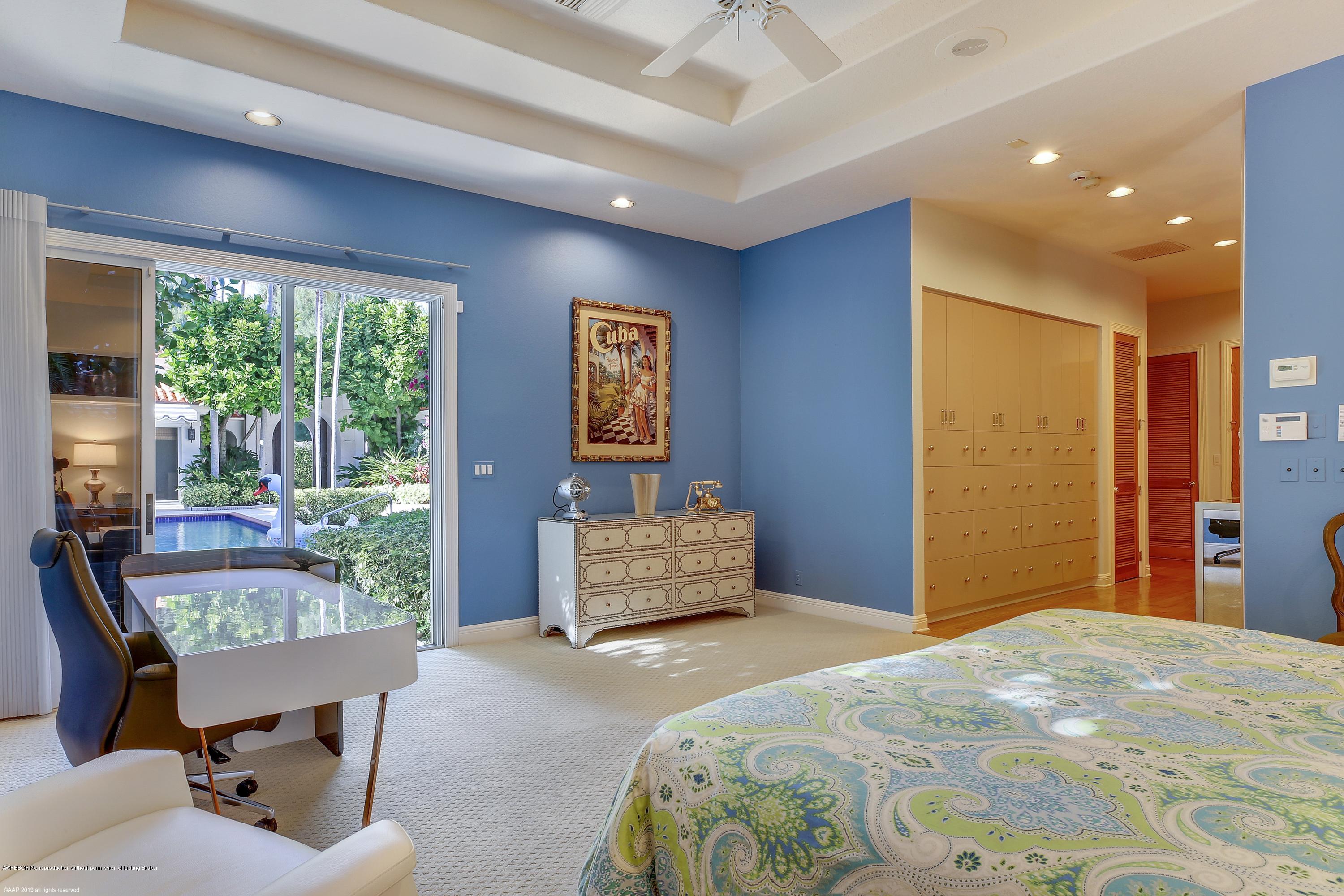 210 Wells Road Palm Beach, FL 33480 - Photo 27 of 65 a bedroom with a bed and wooden floor