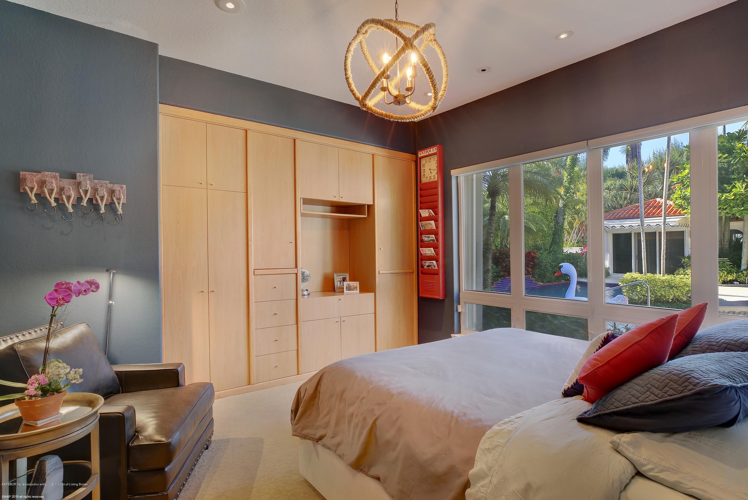 210 Wells Road Palm Beach, FL 33480 - Photo 32 of 65 a bedroom with a bed and a chandelier