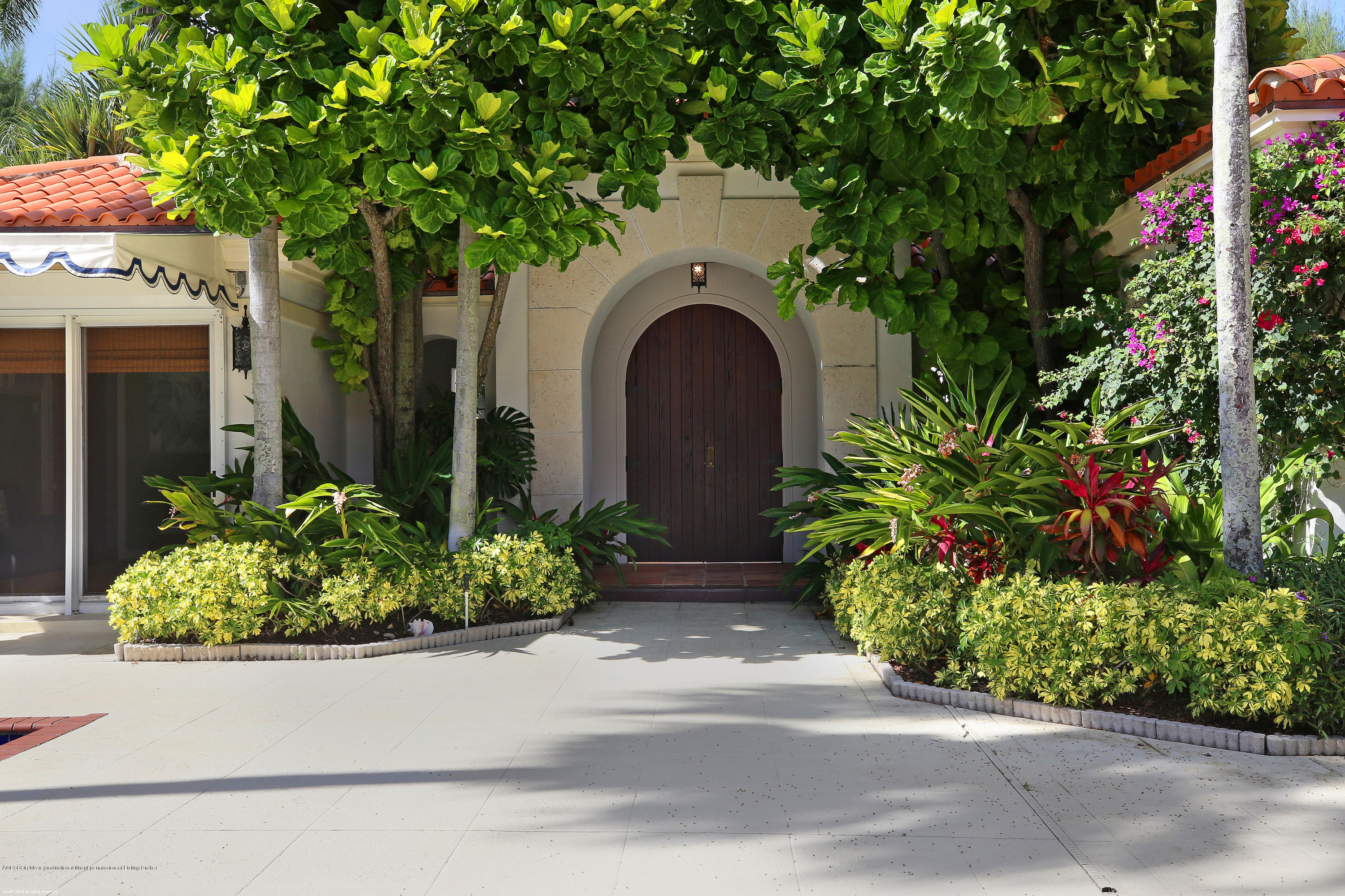 210 Wells Road Palm Beach, FL 33480 - Photo 6 of 65 a front view of a house with a yard