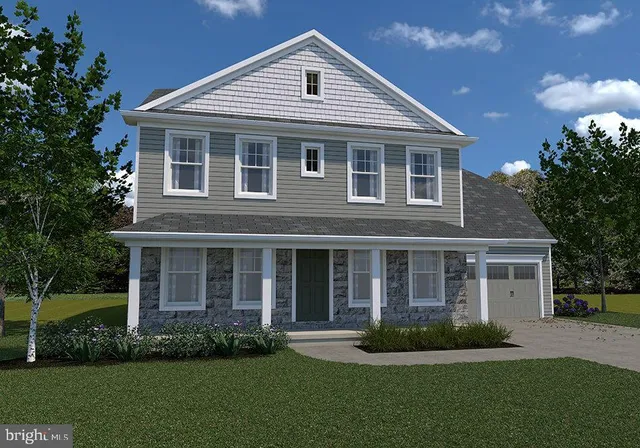 a front view of a house with a yard and green space