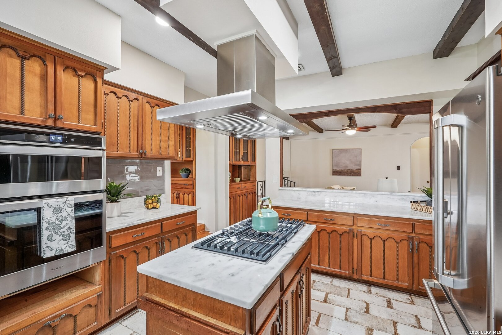 20632 Timber Rose Drive Garden Ridge, TX 78266 - Photo 21 of 46 a kitchen with stainless steel appliances granite countertop a stove refrigerator and cabinets