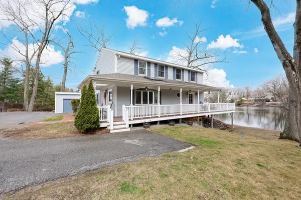 a view of a house with swimming pool next to a yard