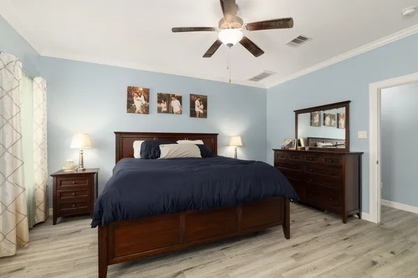 a bedroom with a bed and wooden floor
