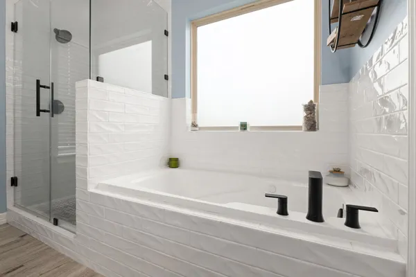 a bathroom with a bathtub and a shower