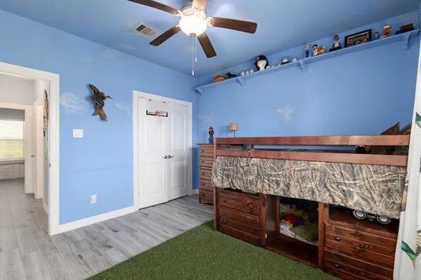 a bed room with a bed and a chandelier