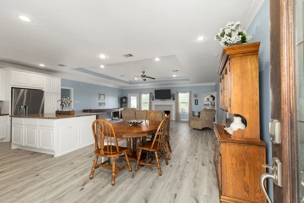 a dining room with furniture and wooden floor