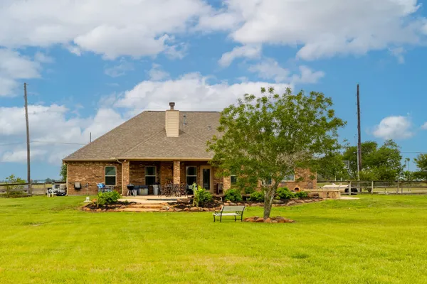 a front view of house with yard and swimming pool