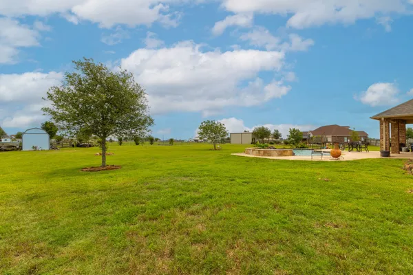 a view of an ocean house in middle of green field