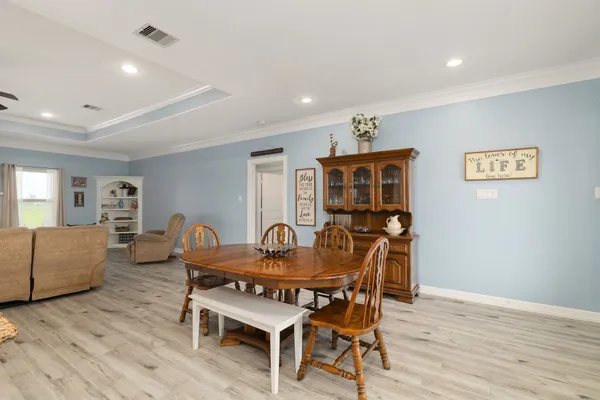 a dining room with furniture and wooden floor