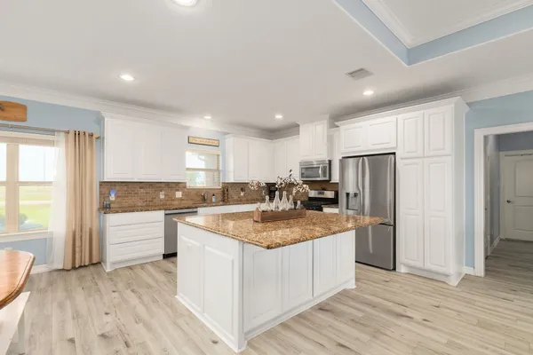 a kitchen with stainless steel appliances granite countertop a stove oven and a refrigerator