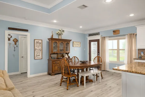 a view of a dining room with furniture window and wooden floor