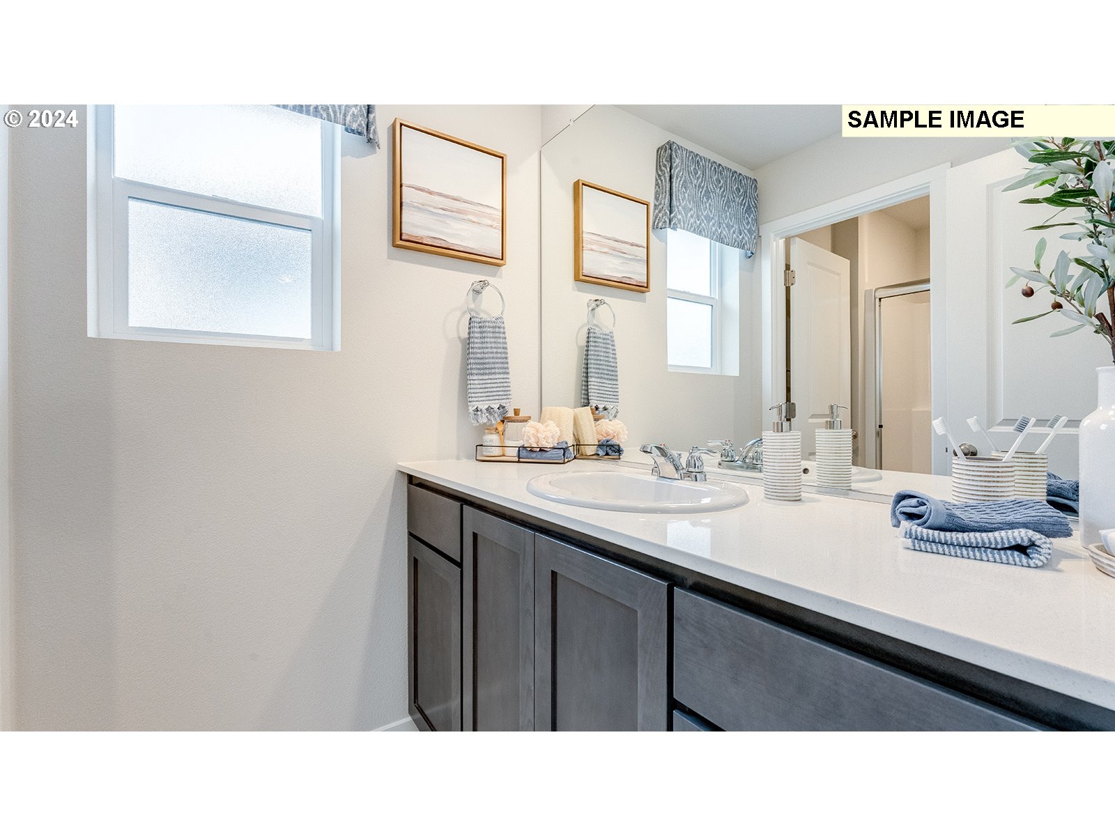 833 Northeast 174th Street Ridgefield, WA 98642 - Photo 26 of 28 a bathroom with a sink a mirror and a window