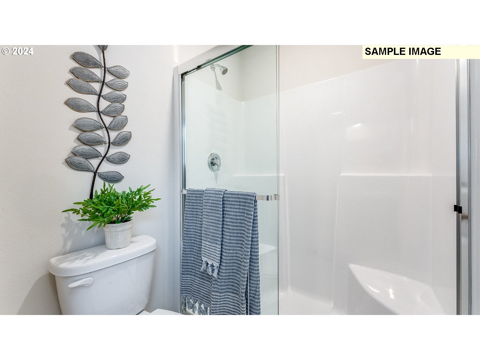 833 Northeast 174th Street Ridgefield, WA 98642 - Photo 27 of 28 a bathroom with a toilet a sink and a shower