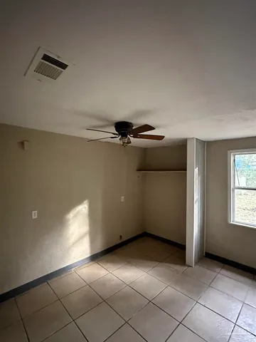 a view of an empty room with windows