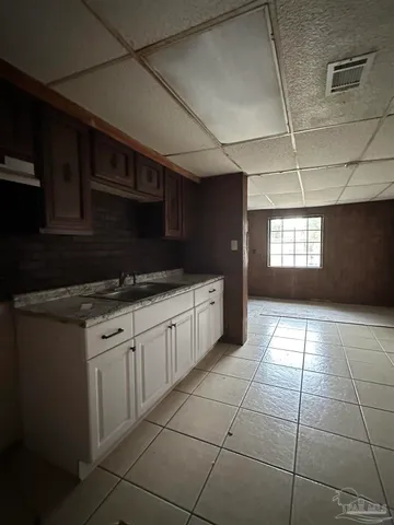 a kitchen with granite countertop a stove a sink and a microwave