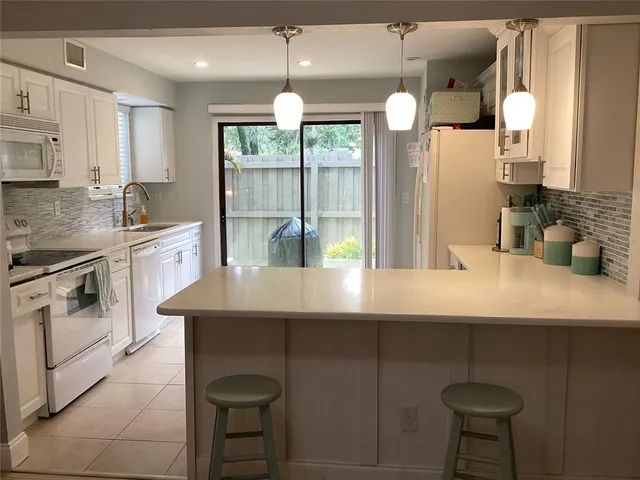 a kitchen with stainless steel appliances a sink a stove and a refrigerator