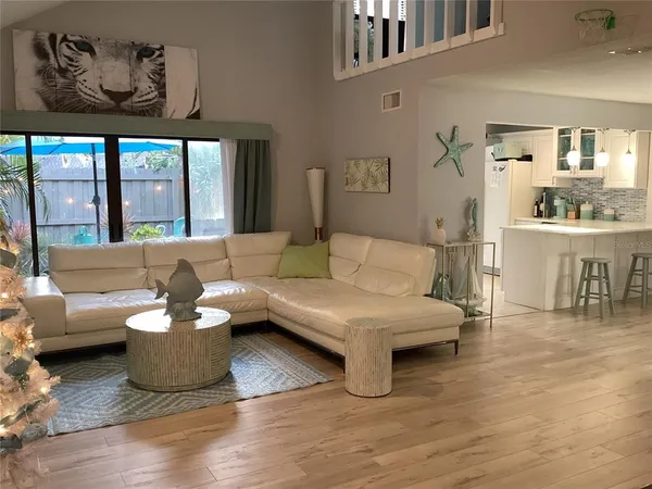 a kitchen with a sink cabinets and wooden floor