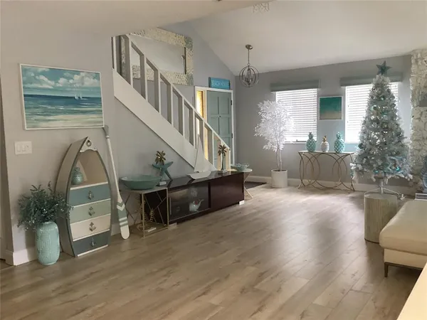 a kitchen with white cabinets and a window