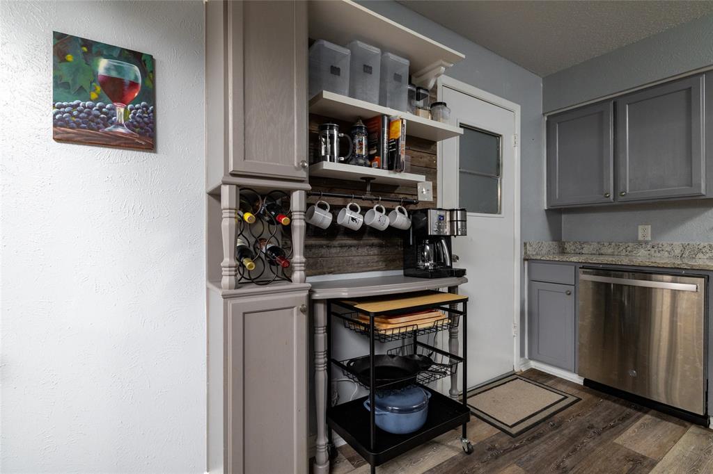 6020 Harrison Way Watauga, TX 76148 - Photo 16 of 32 a kitchen with stainless steel appliances granite countertop a stove and a refrigerator