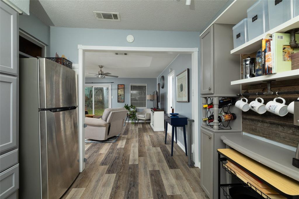 6020 Harrison Way Watauga, TX 76148 - Photo 32 of 32 a kitchen with stainless steel appliances granite countertop a refrigerator and a stove top oven
