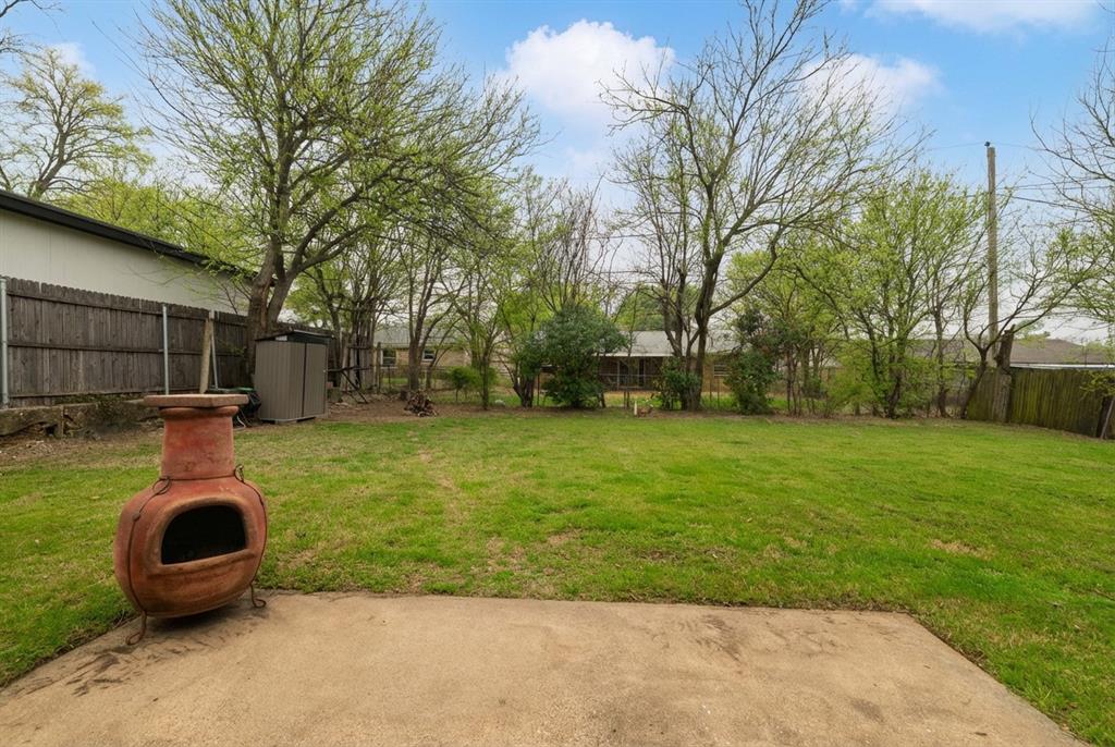 6020 Harrison Way Watauga, TX 76148 - Photo 6 of 32 a backyard of a house with lots of green space