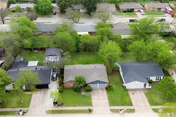 an aerial view of a house with garden space and street view