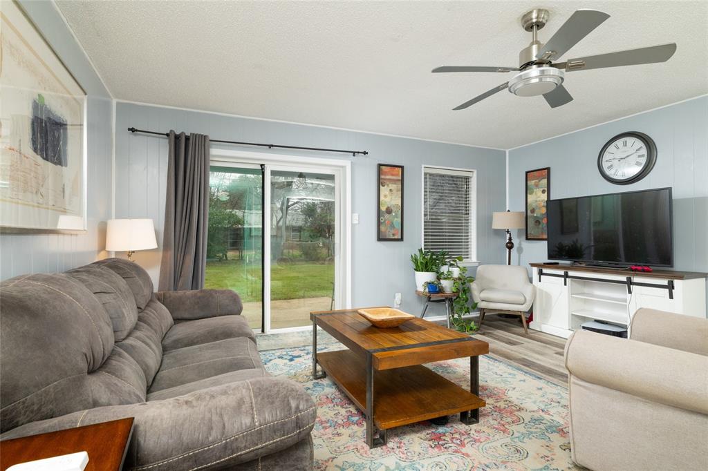 6020 Harrison Way Watauga, TX 76148 - Photo 9 of 32 a living room with furniture a flat screen tv and a large window