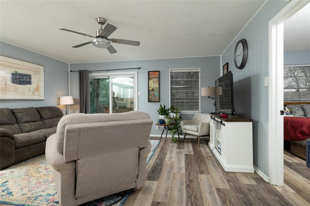 6020 Harrison Way Watauga, TX 76148 - Photo 10 of 32 a living room with furniture wooden floor and a flat screen tv