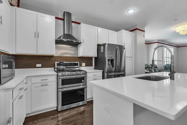 a kitchen with stainless steel appliances a sink stove and refrigerator