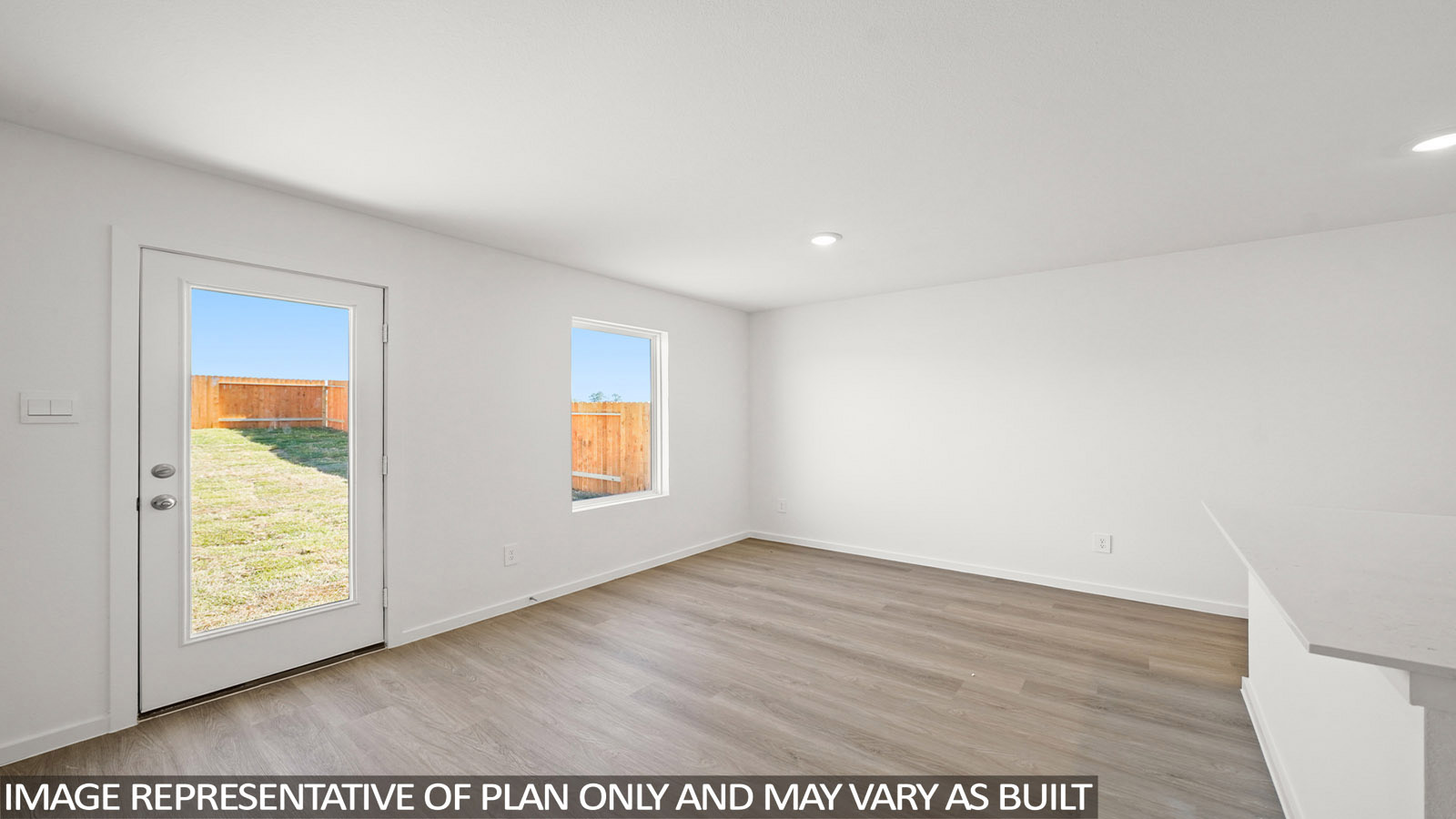 156 Baby Calf Roping Road Jarrell, TX 76537 - Photo 6 of 22 A versatile living space with light wood flooring offers views of the enclosed yard, perfect for customization.