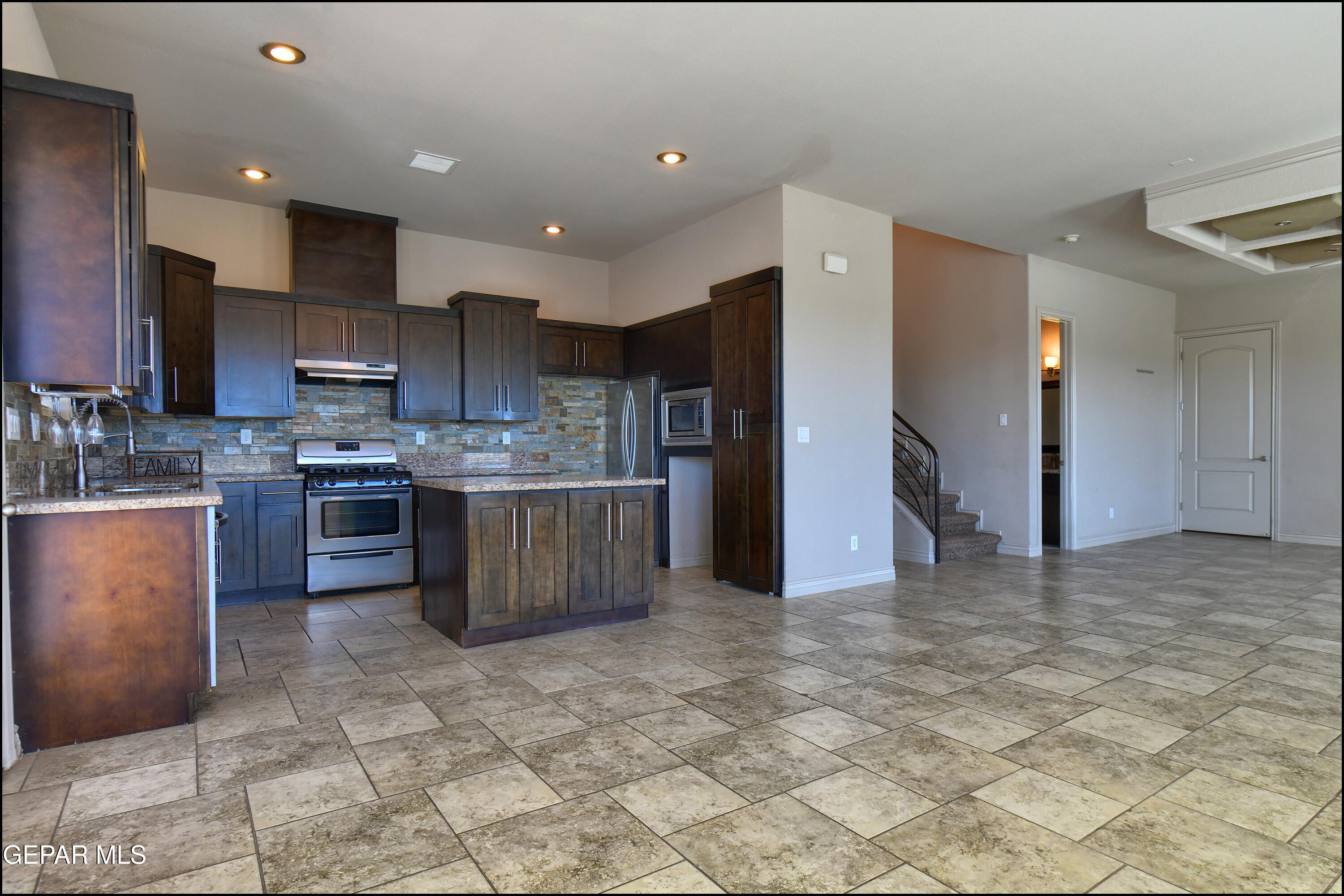 401 Ana Way, Unit B El Paso, TX 79912 - Photo 11 of 54 a kitchen with stainless steel appliances granite countertop a stove refrigerator and a sink