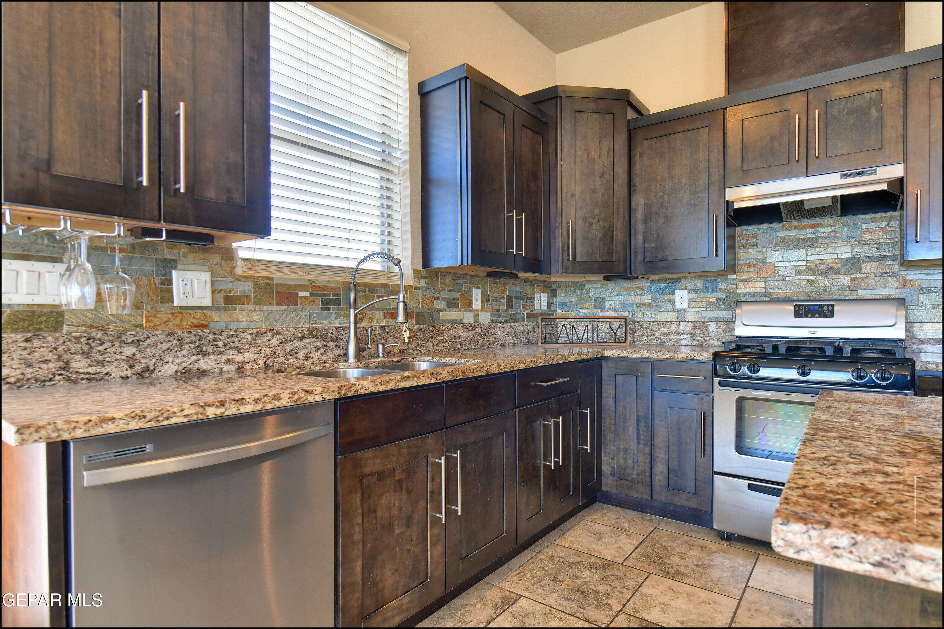 401 Ana Way, Unit B El Paso, TX 79912 - Photo 12 of 54 a kitchen with stainless steel appliances granite countertop a sink stove and cabinets