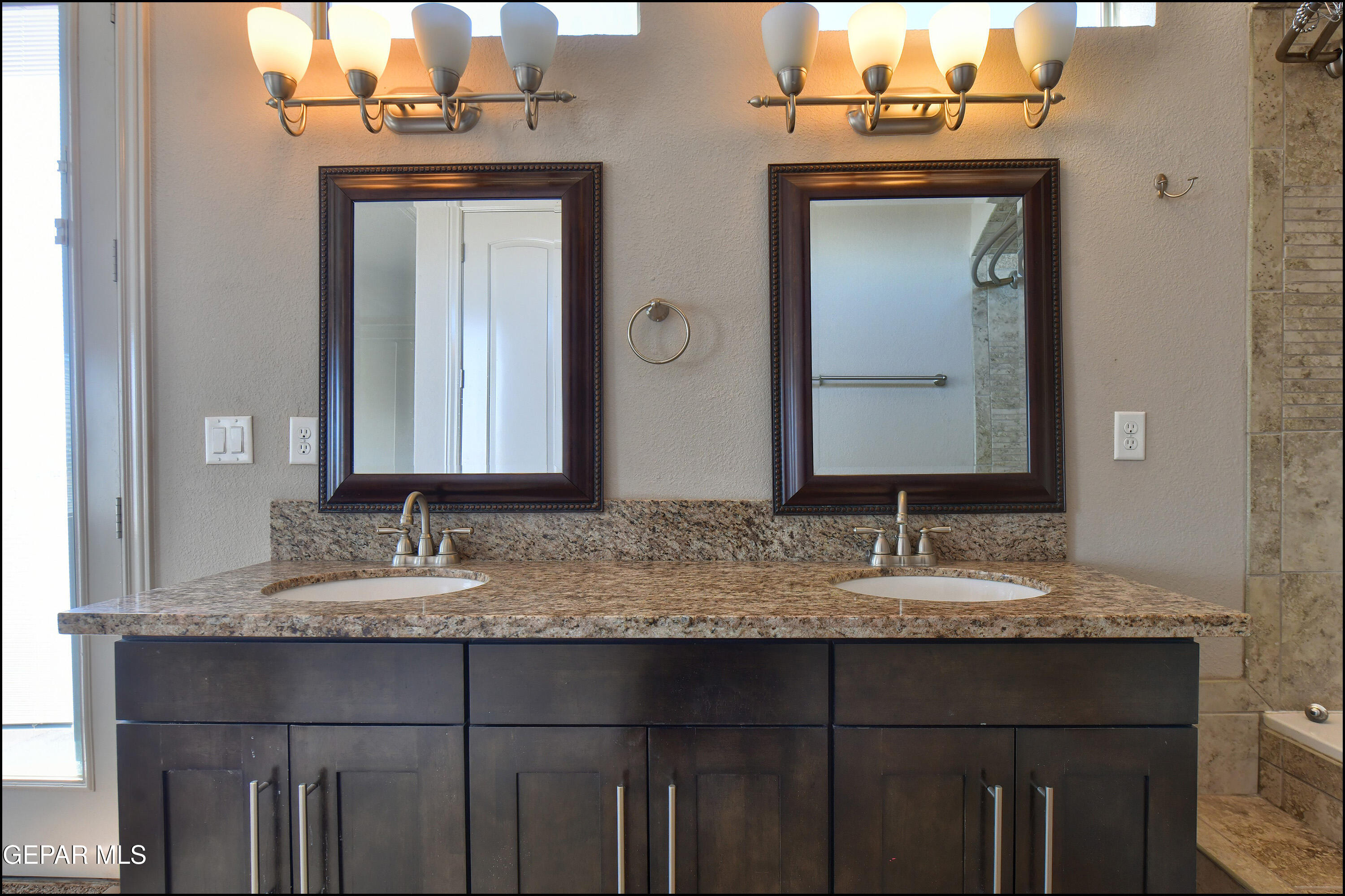 401 Ana Way, Unit B El Paso, TX 79912 - Photo 25 of 54 a bathroom with a granite countertop sink and a mirror