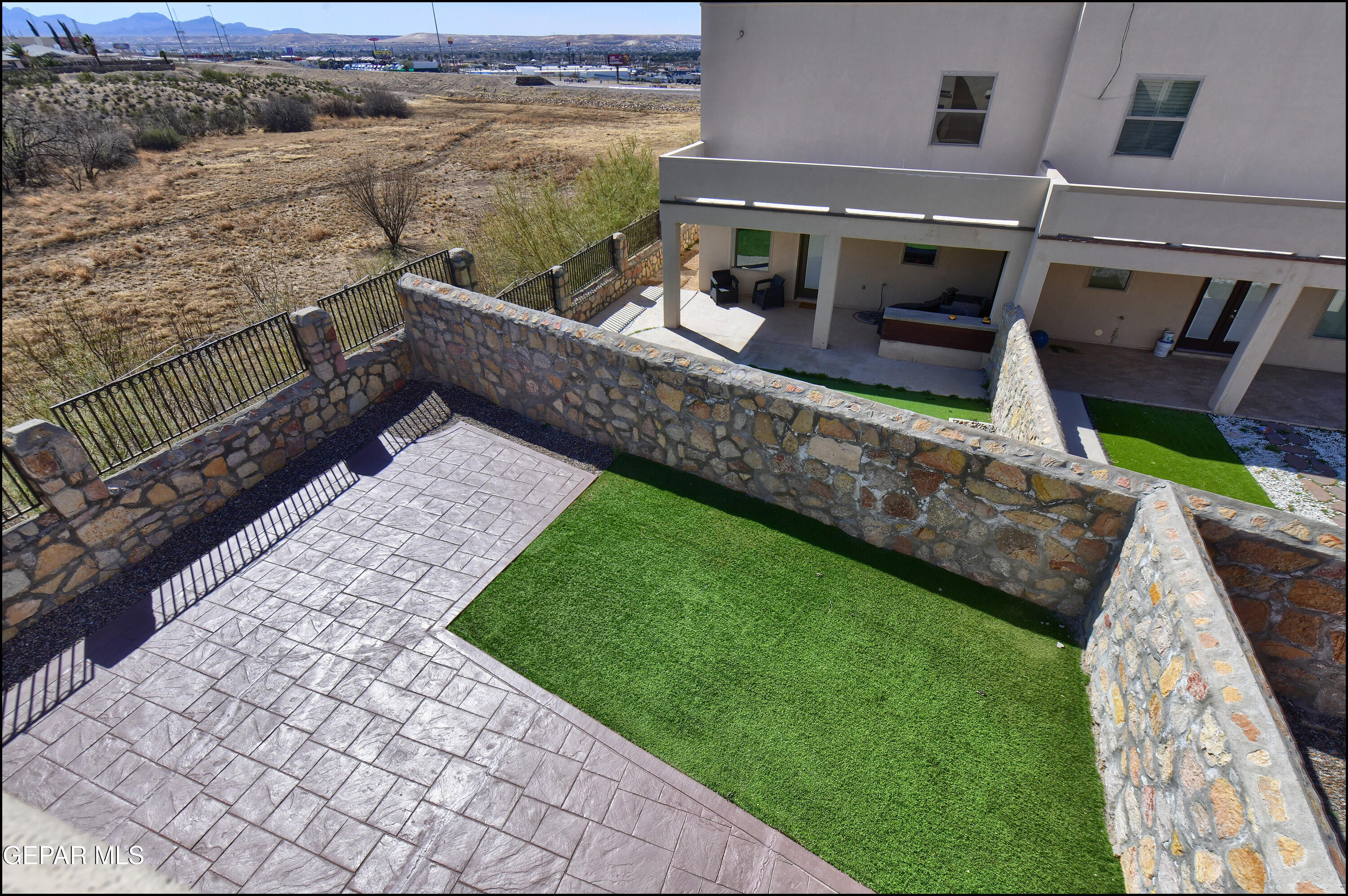 401 Ana Way, Unit B El Paso, TX 79912 - Photo 30 of 54 a view of a balcony with two chairs and a yard
