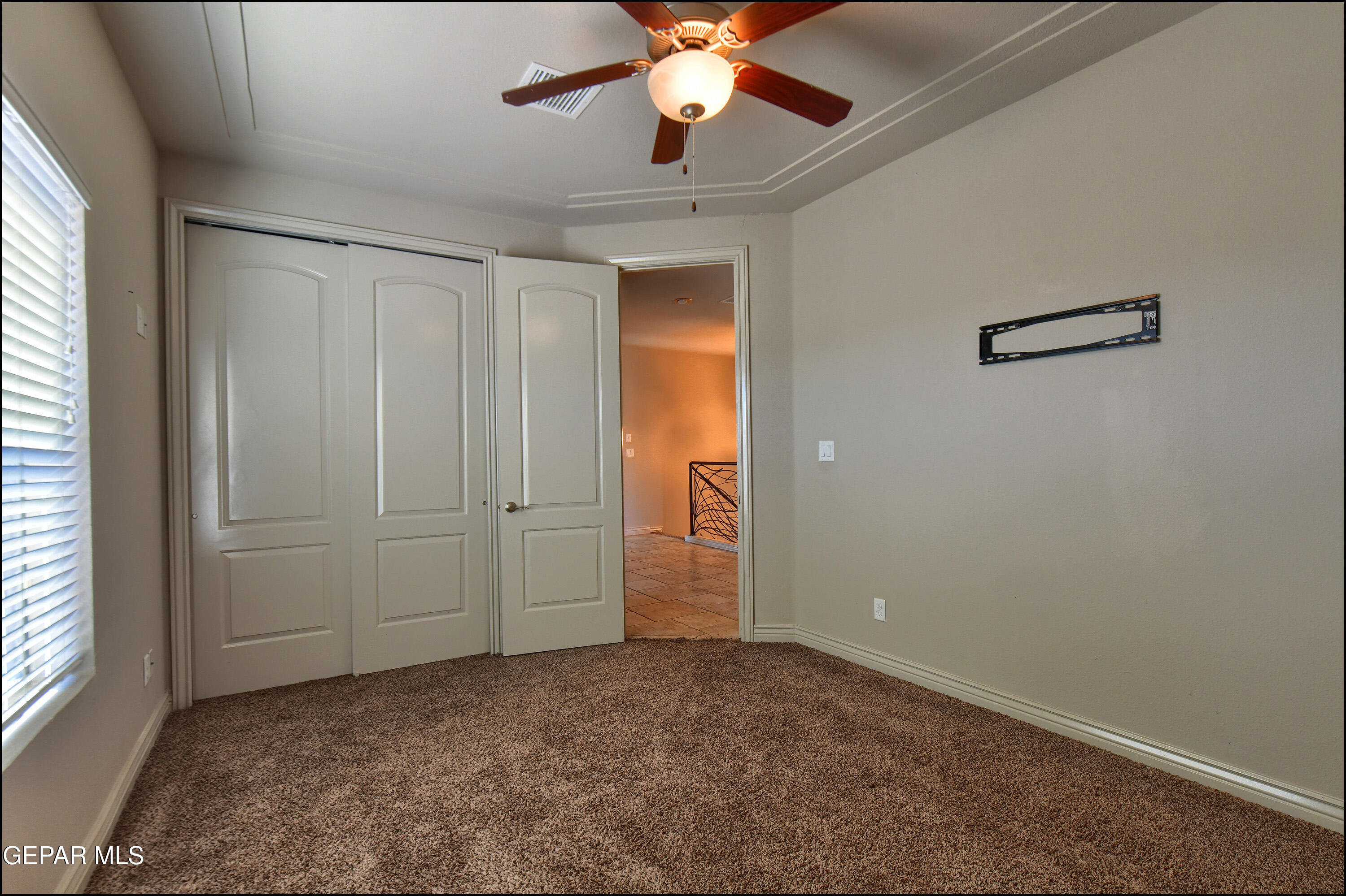 401 Ana Way, Unit B El Paso, TX 79912 - Photo 34 of 54 an empty room with closet and a chandelier fan